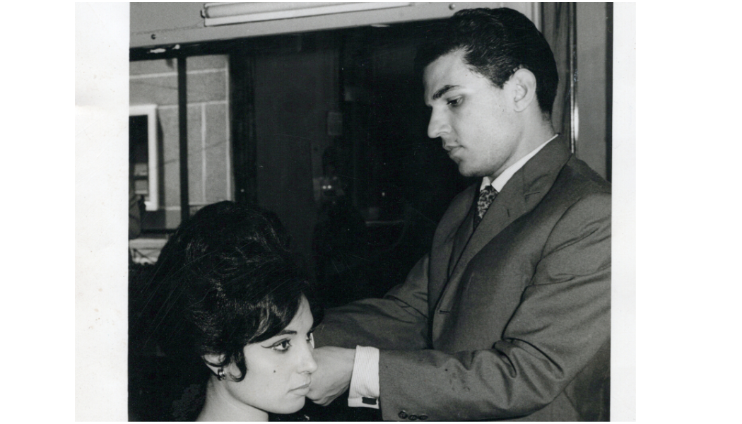 Pierre styling a client’s hair in a historic black-and-white salon photograph